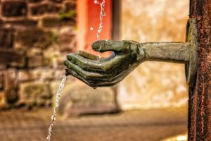 fountain with hands catching water to represent charitable giving